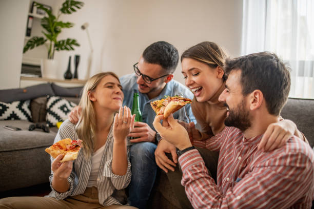 istock Friends having fun at party with delicious pizza. 1239620036