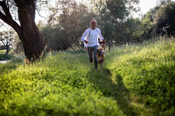 Man running with dog in nature