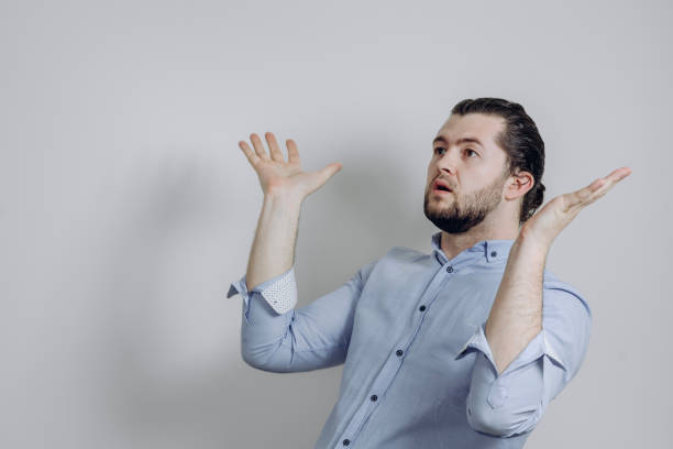 istock Successful handsome businessman with a beard points to the side. 1239631307