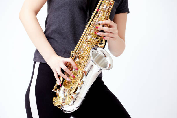 istock Young Japanese woman playing the saxophone 1239634509