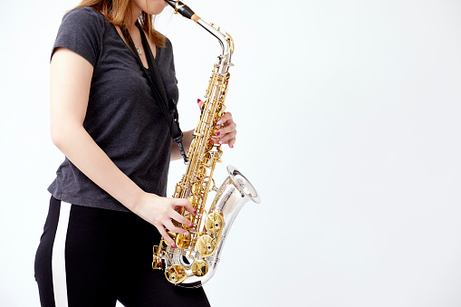 Young Japanese woman playing the saxophone