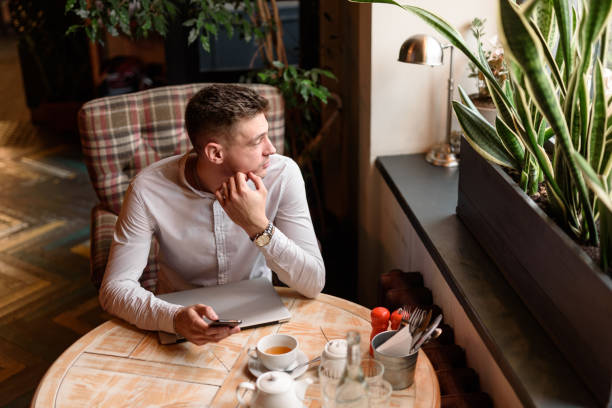 istock Young man resting during lunch in coffee shop 1239636664