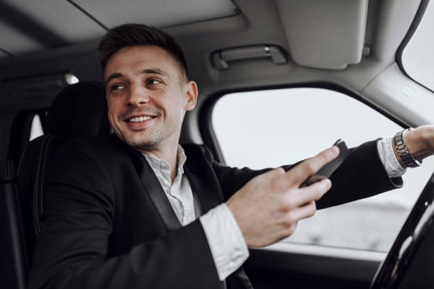 istock Happy handsome guy looking away in automobile 1239636701