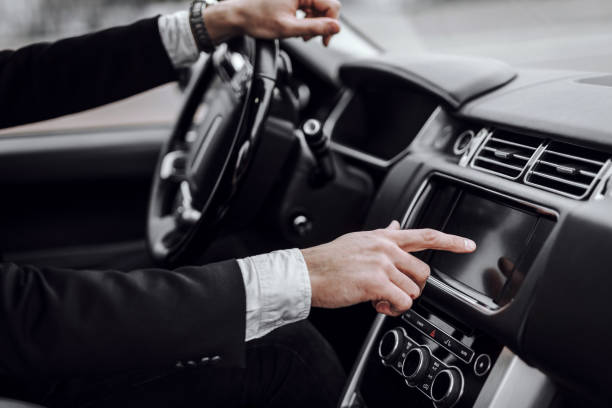 istock Businessman touching screen in modern car dashboard 1239636743
