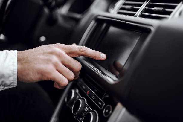 Male driver hand using car audio display Close up of man using gps navigation system in car to travel. Transportation and vehicle concept touchpad stock pictures, royalty-free photos & images