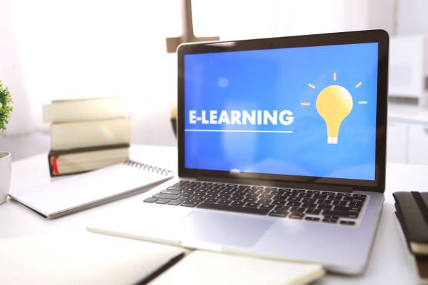 istock E-learning Education Internet Networking . Young businesswoman sitting at table used laptop with inscription on screen e-learning. Online education e-learning. 1239638330