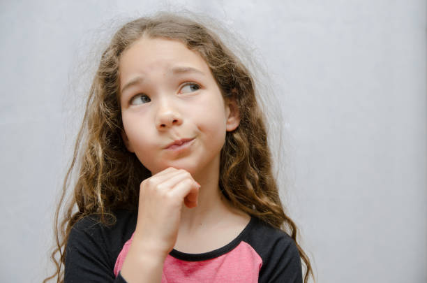 istock Girl thinking on white in background 1239640428