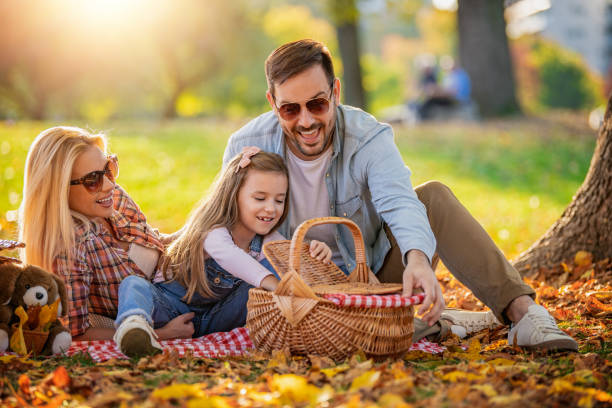 Young happy family of three having fun together stock photo