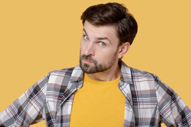 istock Serious young bearded man with an incredulous look. 1239665572