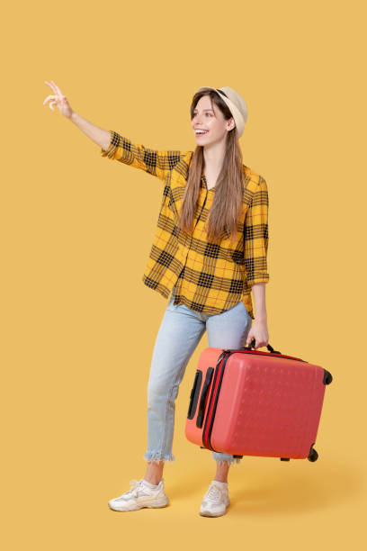 istock Young pretty girl in a hat with a suitcase. 1239665598