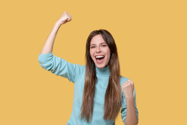 istock Happy laughing young girl with hands up. 1239666108