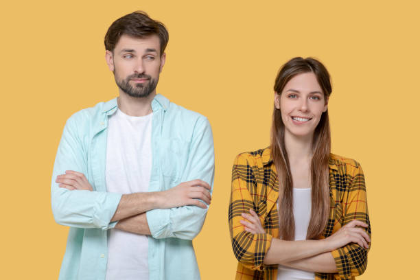 istock Cute young guy and girl standing in identical poses. 1239666715