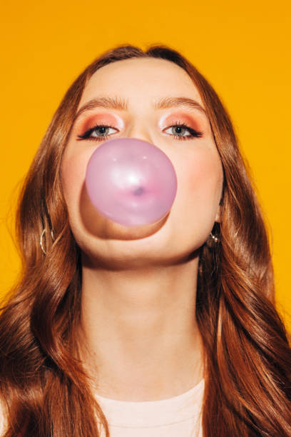 istock pretty girl inflates pink bubble gum 1239679629