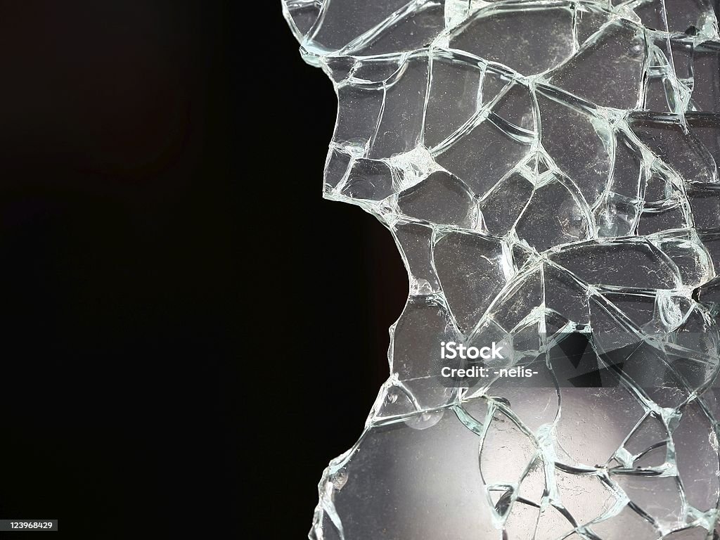 Shattered glass on a black background broken glass with black writing space on the left Shattered Glass Stock Photo
