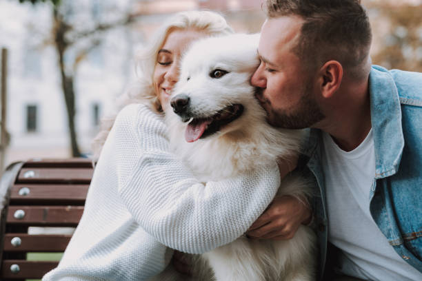istock Young spouses enjoying weekend and sitting on bench with dog 1239692135