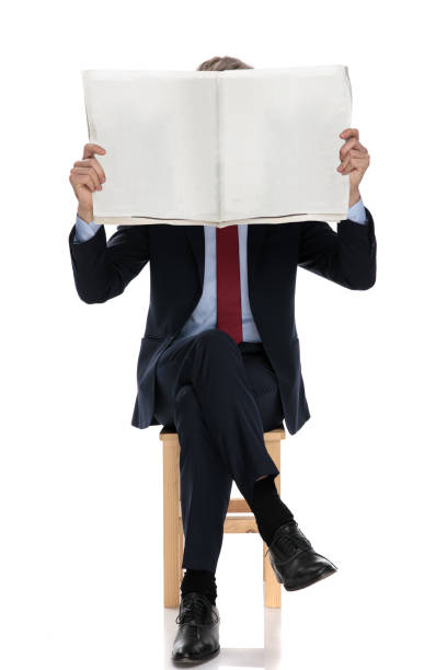 istock young businessman covering face with newspaper 1239710365