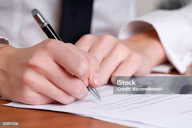 Persons Hand Signing An Important Document Stock Photo - Download Image Now - Agreement, Blank, Business