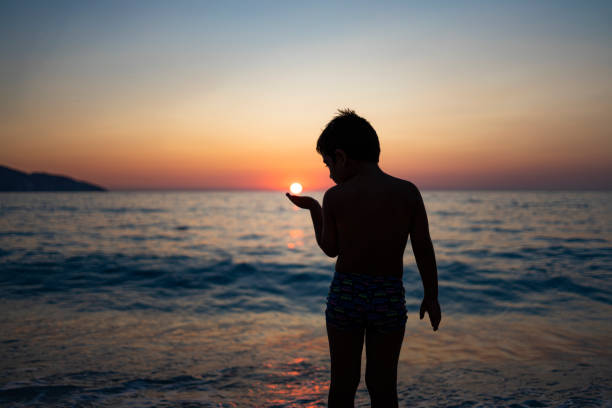 Little boy playing with airplane at the beach