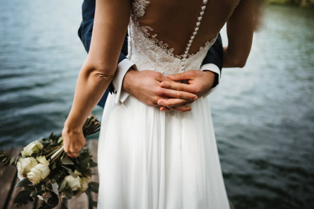 photo of a wedded couple at a lake - fotos de boho imagens e fotografias de stock