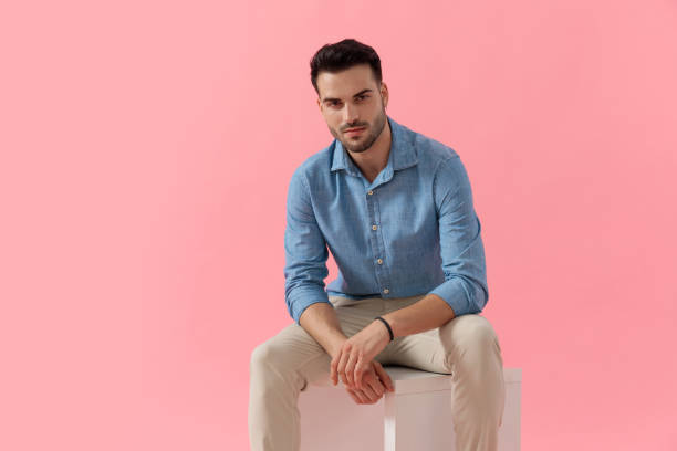 istock businessman sitting on cube and looking at camera happy 1239721991