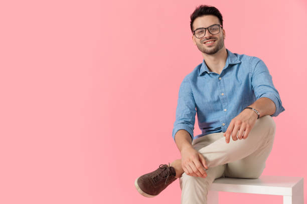 istock businessman sitting on cube and looking at camera happy 1239722560