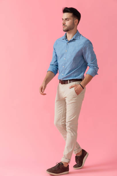 istock businessman walking with hand in pocket and looking ahead serious 1239723626