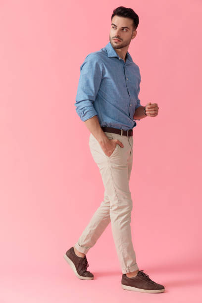 istock businessman walking with hand in pocket looking over shoulder 1239723639