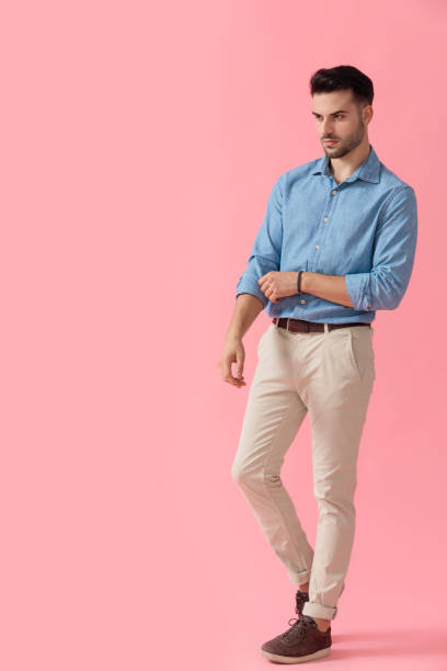 istock businessman standing and looking away while fixing sleeve 1239725202