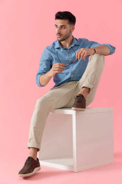 istock businessman sitting on cube and looking aside cool 1239727322
