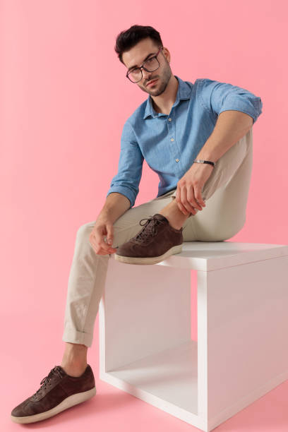 istock businessman sitting on cube and looking at camera serious 1239728982