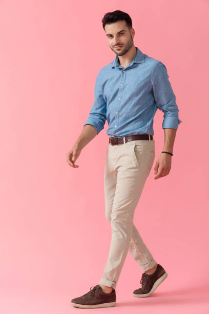 istock businessman walking and looking at camera happy 1239732257