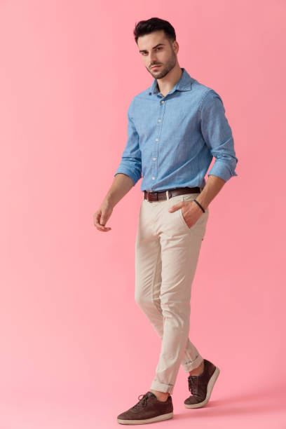 istock businessman walking with hand in pocket and looking at camera 1239732793