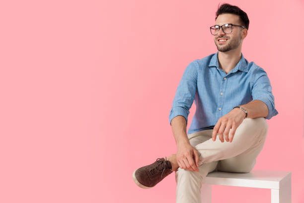 istock businessman sitting on cube while looking away happy 1239733332