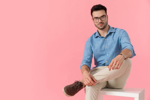 istock businessman sitting on cube and looking at camera serious 1239734404