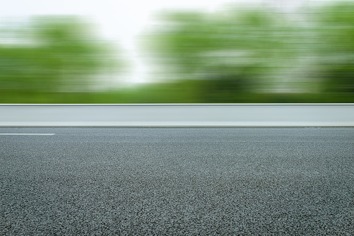 Highway with frontal blurry asphalt road