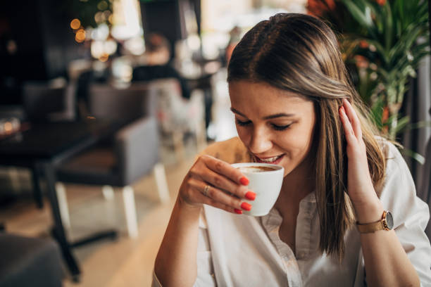 istock Woman drinking coffee in the coffee shop 1239739980