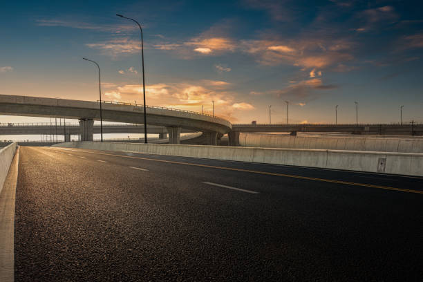 istock Dusk colored clouds in the background, highway overpass curved approach bridge 1239740507