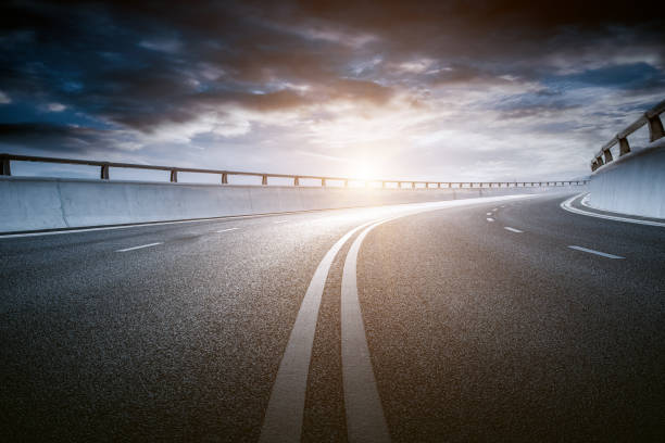 istock Dusk colored clouds in the background, highway overpass curved approach bridge 1239741044