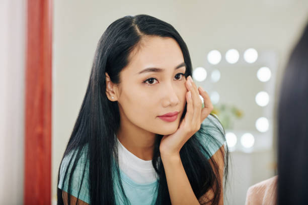 istock Woman applying under eye cream 1239752462