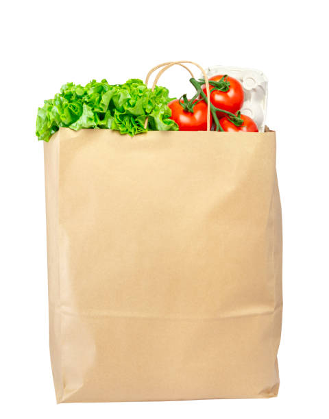 istock Paper bag with lettuce, tomato and spaghetti isolated on white. 1239754183