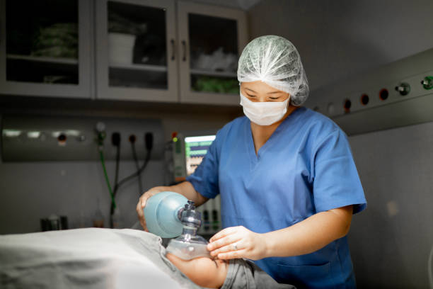 anestesista / enfermera preparando al paciente a la cirugía en el quirófano en el hospital - anestesista fotografías e imágenes de stock