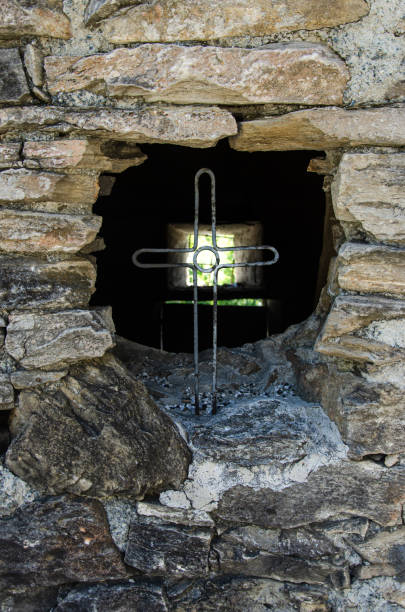 istock Iron cross in a rock wall 1239764445