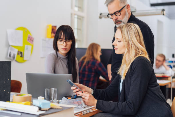 istock Woman with smartphone in office scene 1239765016