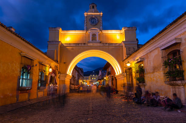 Long exposure at night with motion blur of people by the Santa Catalina Arch, Antigua, Guatemala.