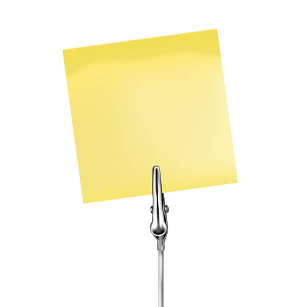 istock Yellow note on a metal memo holder clip. Note on wire silver clamp with place for you text over white background. Office supplies. Vector illustration. 1239777392
