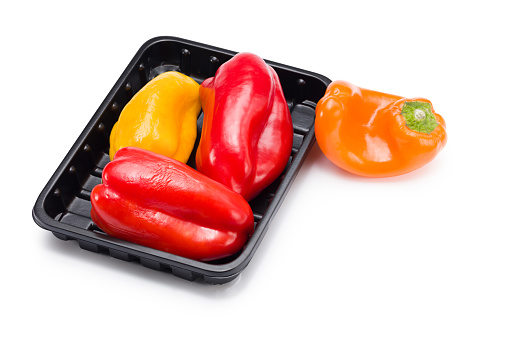 Ora sweet pepper in a black plastic container isolated on white background with clipping path.