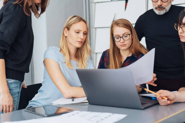 istock Two businesswomen looking at a paper document 1239791595