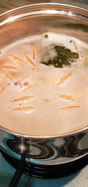 istock Shrimp boil in a saucepan with water and Bay leaf 1239803548