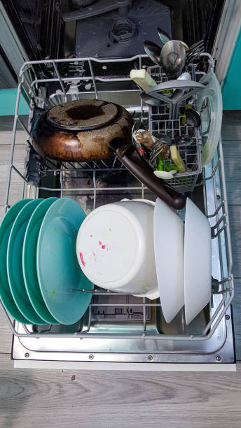 istock filled with different dishes, spoons, forks dishwasher. colorful Dishware inside built-in dishwasher 1239810623