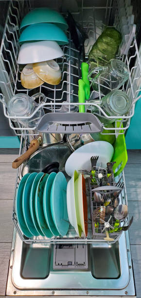 istock image of a dishwasher with a folded dirty dishware 1239810646